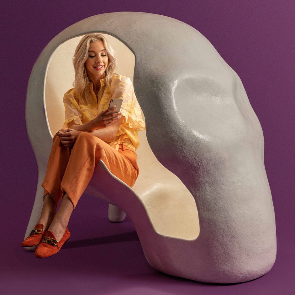 Wonderpass. Lady in a skull shaped chair with purple background